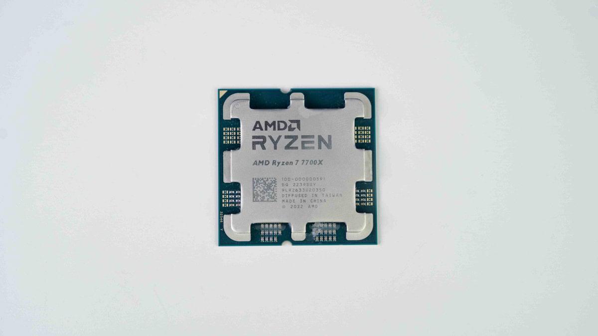 An AMD Ryzen 7 7700X CPU placed on a plain white background.